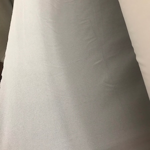 May include: A light blue fabric with a subtle textured surface.