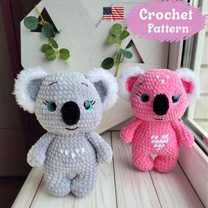 May include: Two handmade crochet koala bears. One is grey with white accents, the other is pink with white accents. Both have black noses, blue eyes, and white hearts. The image includes the text "Crochet Pattern".