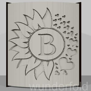 May include: A light-colored wooden panel with a carved sunflower design, a central circle with the letter "B", and heart accents. The panel has a dark brown border and the word "wunderfold" is at the bottom.