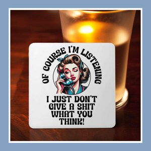 May include: White coaster with a colorful illustration of a woman on the phone. The text reads "Of course I'm listening I just don't give a shit what you think!"