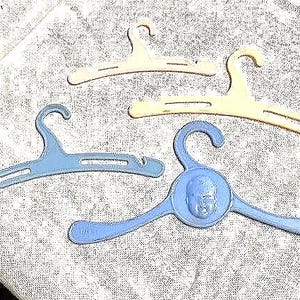 Four adorable vintage doll clothes hangers