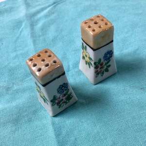 Tiny vintage salt + pepper shakers . Made in Japan, 1960s.