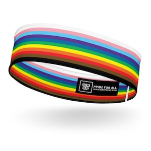 May include: A circular headband featuring a horizontal striped pattern in white, pink, light blue, brown, black, red, orange, yellow, green, blue, and purple. A black rectangular label displays the white text SIX UP PRIDE FOR ALL WWW.SIXUPSHOP.COM.