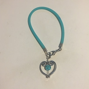 Awareness Bracelet , Ovarian Cancer Cause Awareness Rubber Bracelet with a Silver heart charm and a Teal Crystal bead