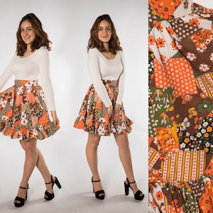 May include: A short, orange, brown, and white patchwork skirt with a ruffled hem. The skirt has a floral pattern and is made of a lightweight fabric.