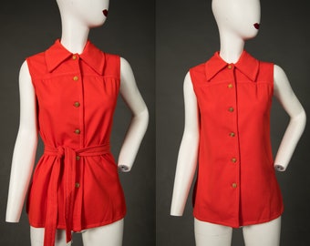 May include: A sleeveless, bright orange top with a collared neckline and a button-up front. The top has a matching fabric belt that ties at the waist.