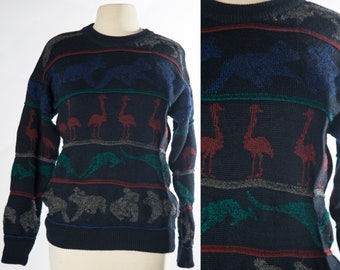 May include: A navy blue sweater with a multi-colored striped pattern. The pattern features a repeating design of birds, fish, and geometric shapes.