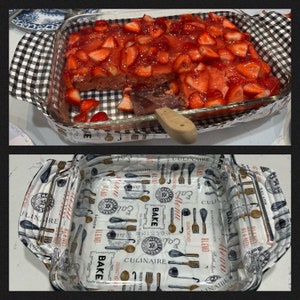 May include: A clear glass baking dish with a white and black checkered pattern on the bottom. The dish is filled with a strawberry dessert topped with a clear red glaze.