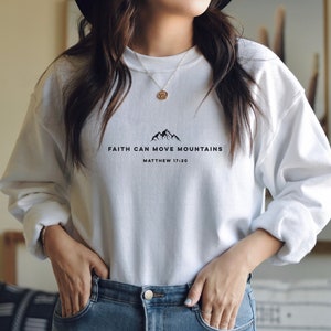 May include: White sweatshirt with a black graphic that says "Faith can move mountains" and "Matthew 17:20".