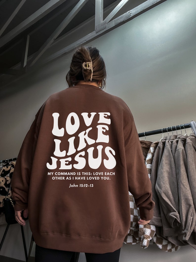 May include: Brown sweatshirt with a white graphic that says "LOVE LIKE JESUS" and the text "MY COMMAND IS THIS: LOVE EACH OTHER AS I HAVE LOVED YOU. John 15:12-13"