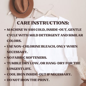 May include: Care instructions for a white t-shirt with long sleeves. The instructions include machine washing cold, inside-out, gentle cycle with mild detergent and similar colors, using non-chlorine bleach only when necessary, no fabric softeners, tumble drying low or hang-drying for the longest life, cool ironing inside-out if necessary, and not ironing the print.