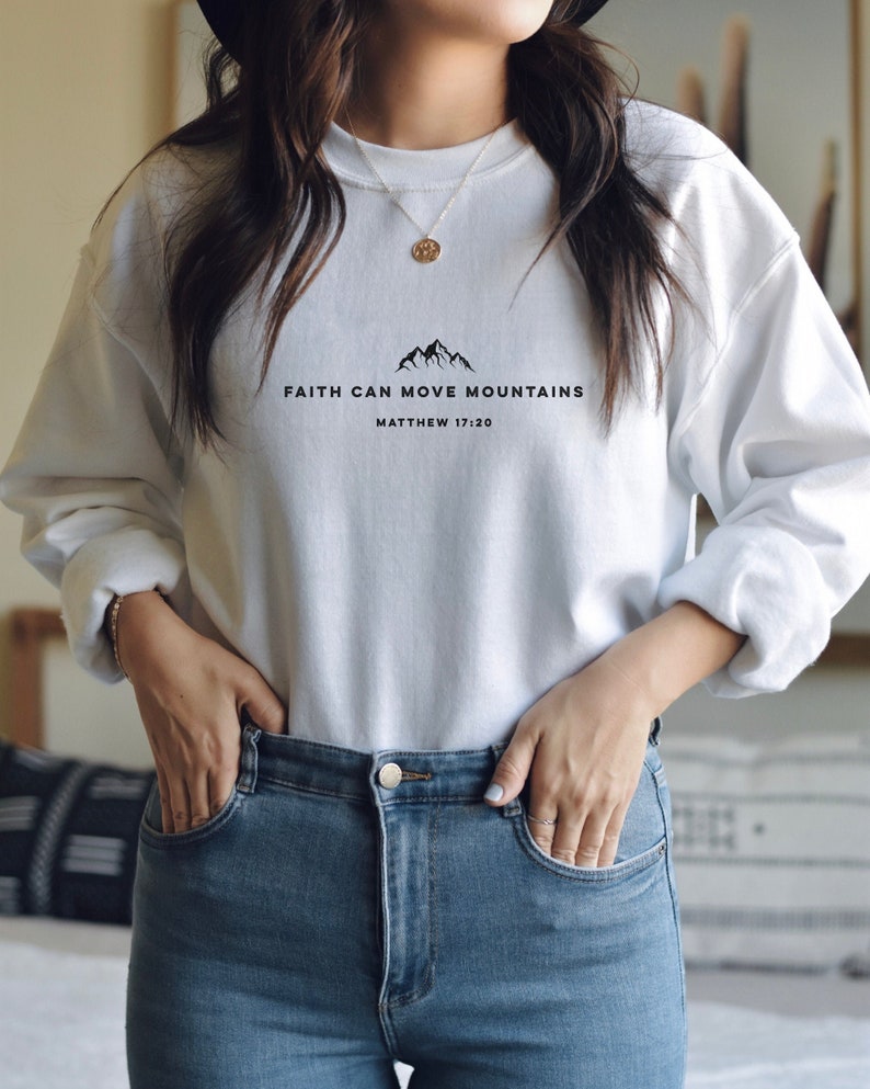 May include: White sweatshirt with a black graphic that says "Faith can move mountains" and "Matthew 17:20".