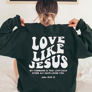 May include: Green sweatshirt with white text that reads "Love Like Jesus" and a quote from John 15:12-13. "My command is this: Love each other as I have loved you."