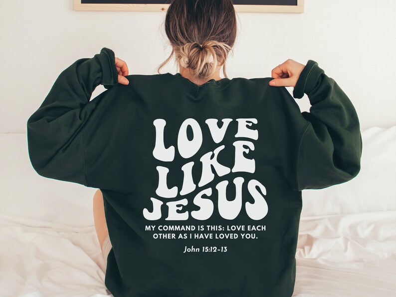 May include: Green sweatshirt with white text that reads "Love Like Jesus" and a quote from John 15:12-13. "My command is this: Love each other as I have loved you."
