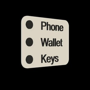 May include: A white checklist with three black circles and the words "Phone", "Wallet", and "Keys" written in black.