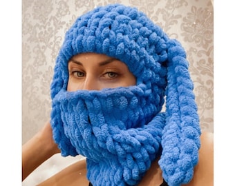 May include: A blue knitted balaclava with long ear flaps. The balaclava covers the head and face, with a hole for the eyes and mouth.