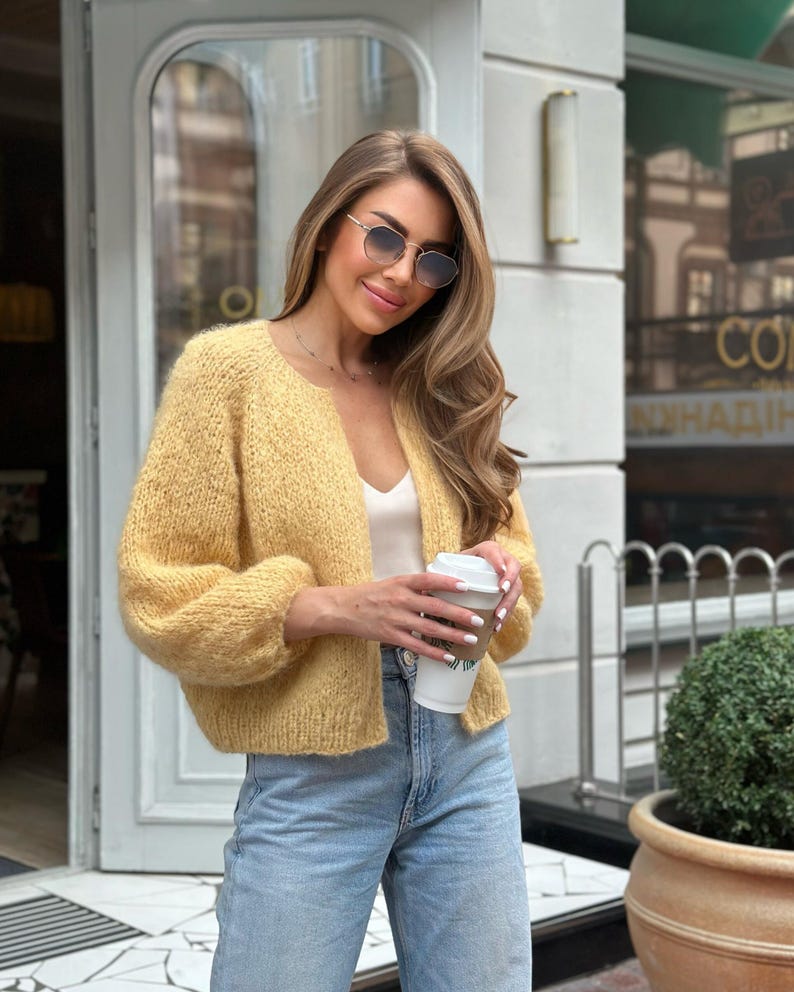 Yellow handmade sweater styled as cottagecore clothing with denim jeans