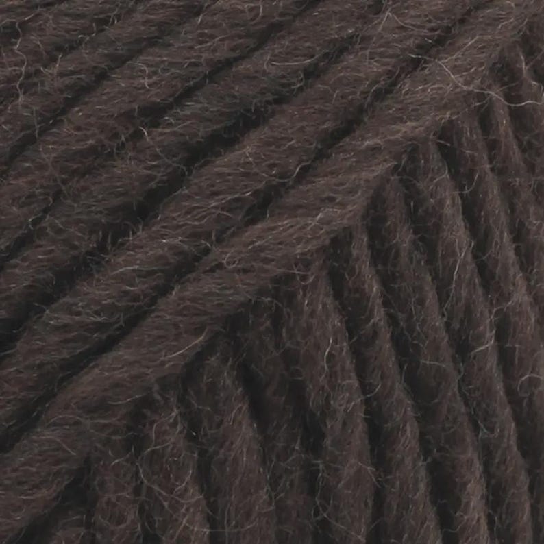 May include: A close-up view of dark brown yarn featuring a multi-ply twisted construction. The fibres exhibit a soft, slightly fuzzy texture with visible individual strands wound together in a consistent diagonal pattern across the entire frame.