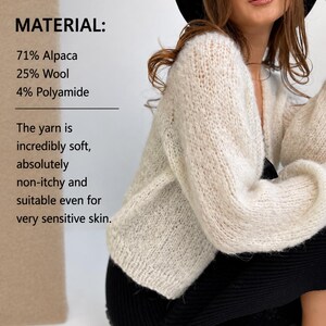 May include: A cream-coloured, long-sleeved, knitted cardigan with a V-neckline. Text on the image reads: MATERIAL: 71% Alpaca, 25% Wool, 4% Polyamide. The yarn is incredibly soft, absolutely non-itchy and suitable even for very sensitive skin.