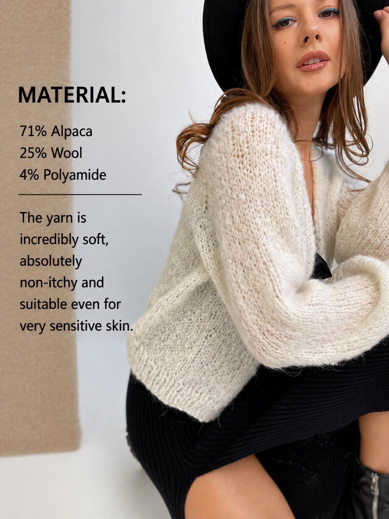 May include: A cream-coloured, long-sleeved, knitted cardigan with a V-neckline. Text on the image reads: MATERIAL: 71% Alpaca, 25% Wool, 4% Polyamide. The yarn is incredibly soft, absolutely non-itchy and suitable even for very sensitive skin.