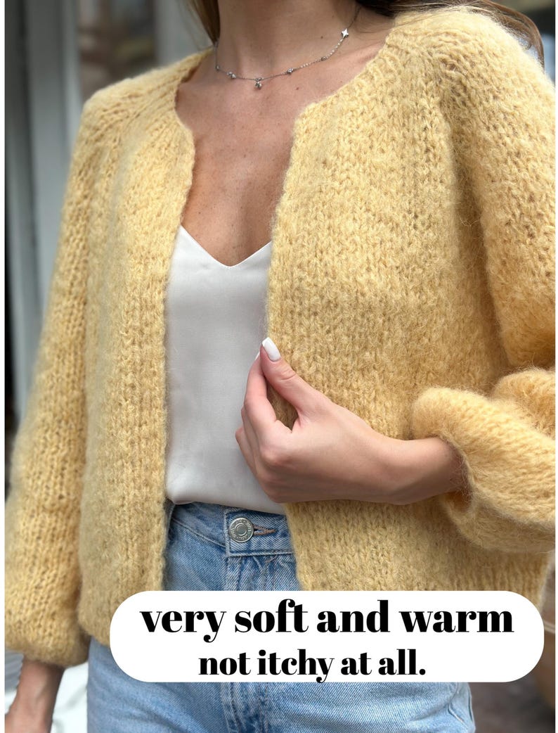 Yellow alpaca jacket detail with textured stitches and rolled cuffs