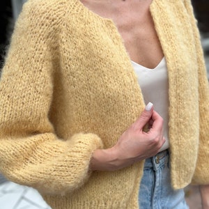 Close-up of alpaca sweater texture with soft knit balloon sleeve