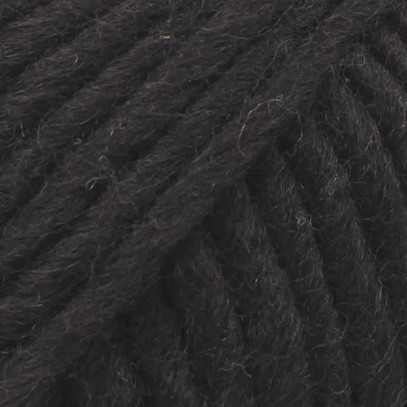May include: A close-up view of black yarn showing the twisted fibre construction. The strands are tightly wound together, creating a textured surface with visible individual fibres and a consistent dark matte black colour throughout the material.