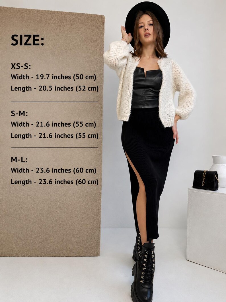 May include: A cream-coloured knit cardigan with long sleeves, worn with a black leather-look top and a black midi skirt featuring a side slit. The image includes a size chart listing widths and lengths from 50 cm to 60 cm for sizes XS-L.
