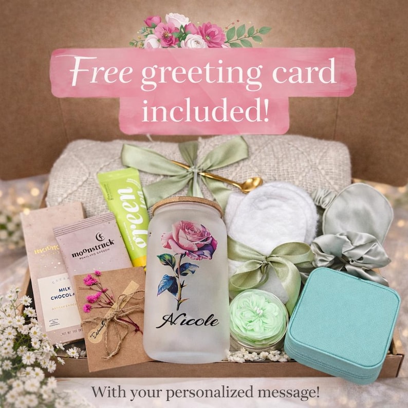 May include: A gift box filled with self-care items, including a frosted glass with a rose design and the name "Nicole", a green tube, a small jewelry box, and a small card. The box is decorated with ribbons and flowers. Text on the image reads "Free greeting card included!"