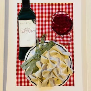 May include: Textile art piece featuring a wine bottle, a glass of red wine, and a plate of pasta on a red and white checkered background. The wine bottle has a label with text. The pasta is beige and the plate is white.