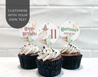 May include: Three chocolate cupcakes in black liners topped with white frosting and cookie crumbles, each featuring a circular paper topper with illustrations of books, an owl with a hat, and text reading Happy Birthday, 11, and Harrison's Magical Day.