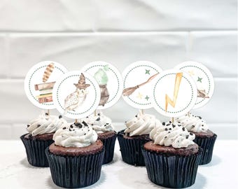 May include: A set of chocolate cupcakes in black paper liners topped with white frosting and cookie crumbles, each featuring a circular paper topper with watercolor illustrations of an owl, a broom, a lightning bolt, and books.