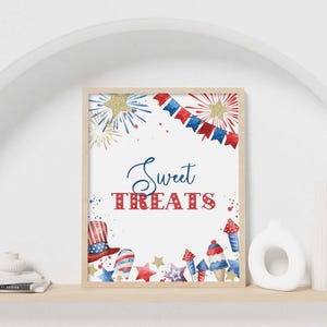 May include: A framed wall art print featuring the text Sweet TREATS in blue and red. The design includes watercolor illustrations of red, white, and blue fireworks, stars, a top hat, and ice cream cones on a white background.