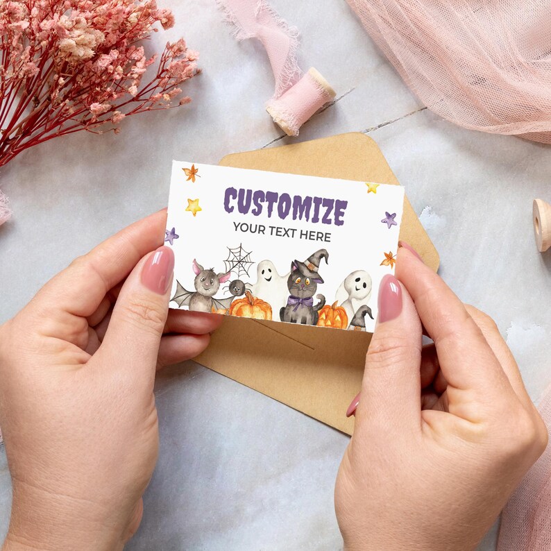 May include: A customizable Halloween card with a black cat, ghosts, bats, and spiders. The card has a purple and yellow star pattern and the text "CUSTOMIZE YOUR TEXT HERE".
