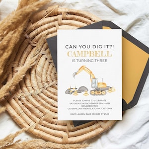 May include: A white rectangular birthday invitation card featuring a watercolor illustration of a yellow excavator, traffic cones, and rocks. The text reads: CAN YOU DIG IT?! CAMPBELL IS TURNING THREE, with event details and RSVP information.