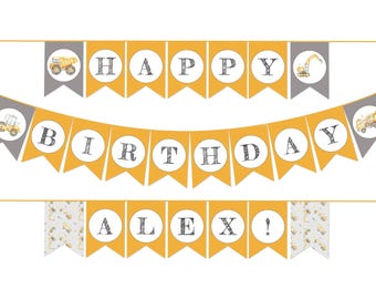 May include: A decorative birthday banner featuring yellow and gray pennants with construction vehicle illustrations. The banner displays the text HAPPY BIRTHDAY ALEX! in white circles with black lettering, arranged across three horizontal rows.