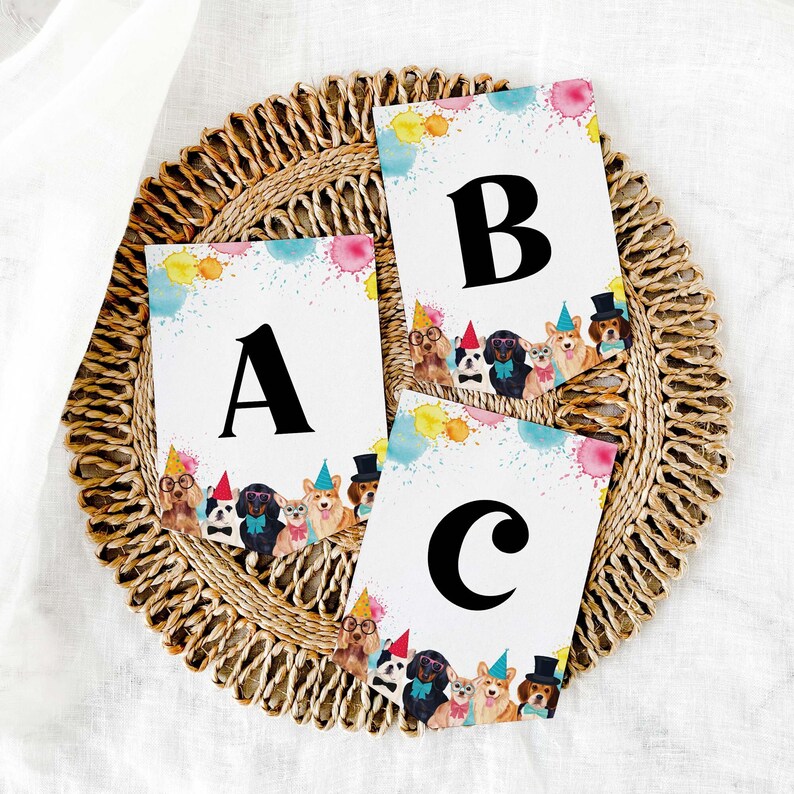 May include: Three colorful cards with a watercolor background and a border of cartoon dogs wearing party hats. The cards feature the letters A, B, and C in black.