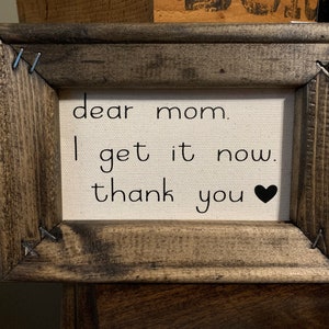 May include: A framed canvas with the text "dear mom. I get it now. thank you" and a black heart.