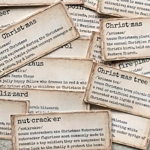 May include: Close-up of vintage-style cards with definitions of Christmas-related words, such as "reindeer", "Merry Christmas", "blizzard", "nutcracker", "fireplace", and "Christmas tree".