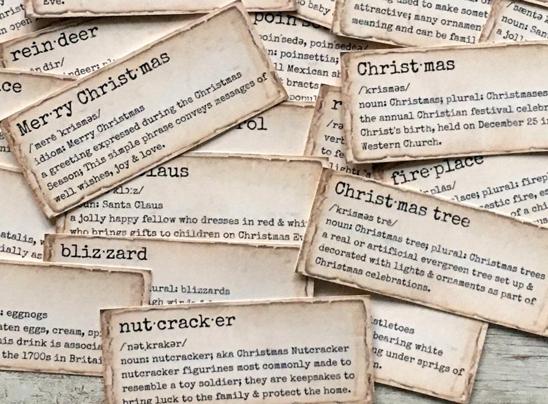 May include: Close-up of vintage-style cards with definitions of Christmas-related words, such as "reindeer", "Merry Christmas", "blizzard", "nutcracker", "fireplace", and "Christmas tree".