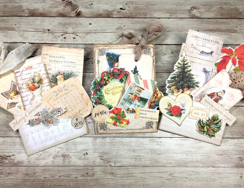 May include: A collection of vintage Christmas decorations and ephemera, including a wreath, a calendar, a Christmas tree, and a heart-shaped ornament. The decorations are arranged on a wooden surface and feature a variety of colors, including red, green, and gold.