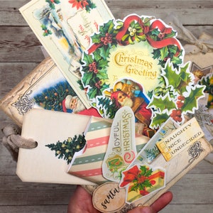 May include: A collection of vintage Christmas-themed paper ephemera, including a wreath with the text "Christmas Greeting", a tag with the text "Joyful Christmas", and a tag with the text "Naughty, Nice, Undecided".