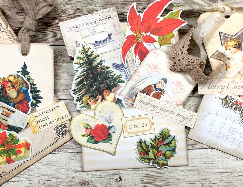 May include: A collection of vintage Christmas-themed paper ephemera, including a red poinsettia, a Christmas tree, a Santa Claus, a holly sprig, and a heart-shaped card with a red rose. The ephemera is arranged on a wooden surface with the text "making spirits bright" and "Dec. 25" visible.
