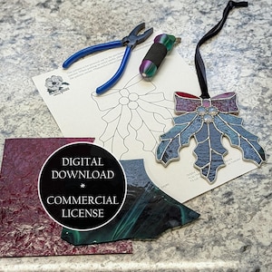 May include: A stained glass holly leaf ornament with a red and purple bow, blue leaves, and a black ribbon. Also shown are glass pieces, a pattern, and tools. The image includes a digital download with a commercial license.
