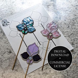May include: Three stained glass flower hair pins in blue, purple, and pink with gold-coloured stems, resting on a floral design template. A black circle with white text reads "DIGITAL DOWNLOAD * COMMERCIAL LICENSE".