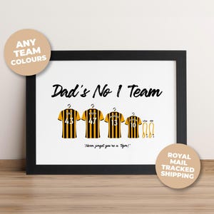 May include: A framed print featuring the text Dad's No 1 Team and Never forget you're a Tiger! with four yellow and black striped jerseys hanging on hangers, each with a name and number, plus two yellow leads for pets named Lola and Rex.