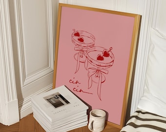 May include: A pink framed print with a red illustration of two martini glasses with hearts in them. The text "cin cin" is written below the glasses.