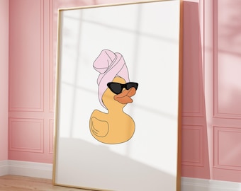 May include: A yellow rubber duck wearing pink sunglasses and a pink towel on its head. The duck is looking to the right.