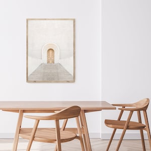 May include: A framed print of a white building with a golden door and steps leading up to it. The building has a white background and a white archway above the door.