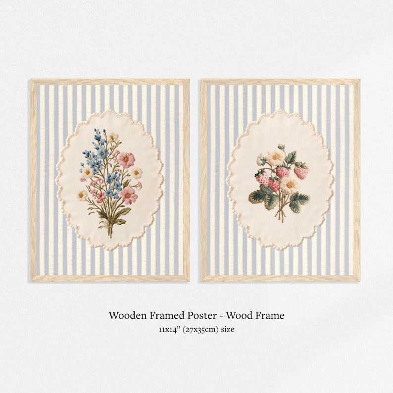 May include: Two framed posters, each with a floral design. One features blue and pink flowers, the other strawberries and white flowers. The background is a light blue and white striped pattern. The frames are wood, and the size is 11x14 inches.